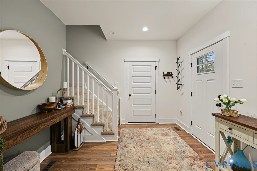 3851 County Line Road, Flemings Mill, Goochland, VA 23084 Entryway featuring wood-finish flooring, a white five-panel door with a glass lite, and a staircase with a white balustrade
