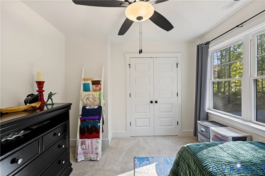 3851 County Line Road, Flemings Mill, Goochland, VA 23084 Interior room featuring wall-to-wall carpeting, double doors with paneled detailing, a multi-blade ceiling fan with integrated lighting, and dual windows