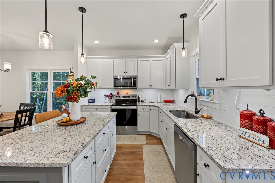 3851 County Line Road, Flemings Mill, Goochland, VA 23084 Kitchen featuring white cabinetry, stone-surface countertops, central island, stainless steel appliances, and wood-finish flooring