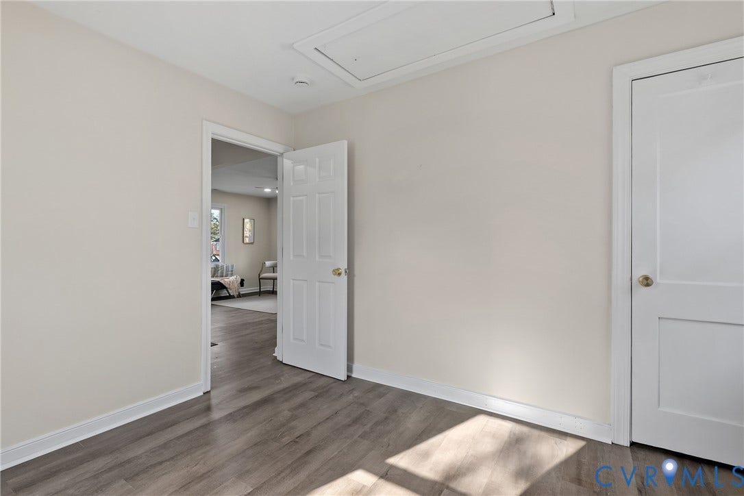 3207 Winchester Street, Henrico, VA 23231 Interior space featuring wood-finish flooring, two-panel interior doors with metallic hardware, and an attic access panel