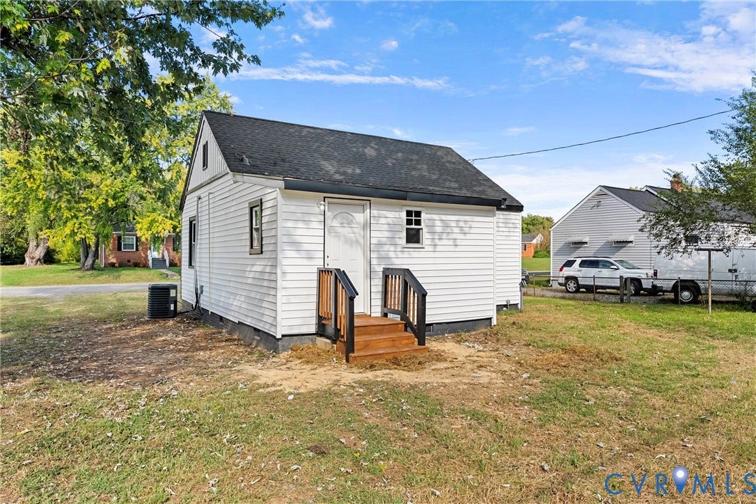 3207 Winchester Street, Henrico, VA 23231 Exterior featuring white horizontal siding, a dark shingled gable roof, and a wooden entrance stoop with dark-toned railings