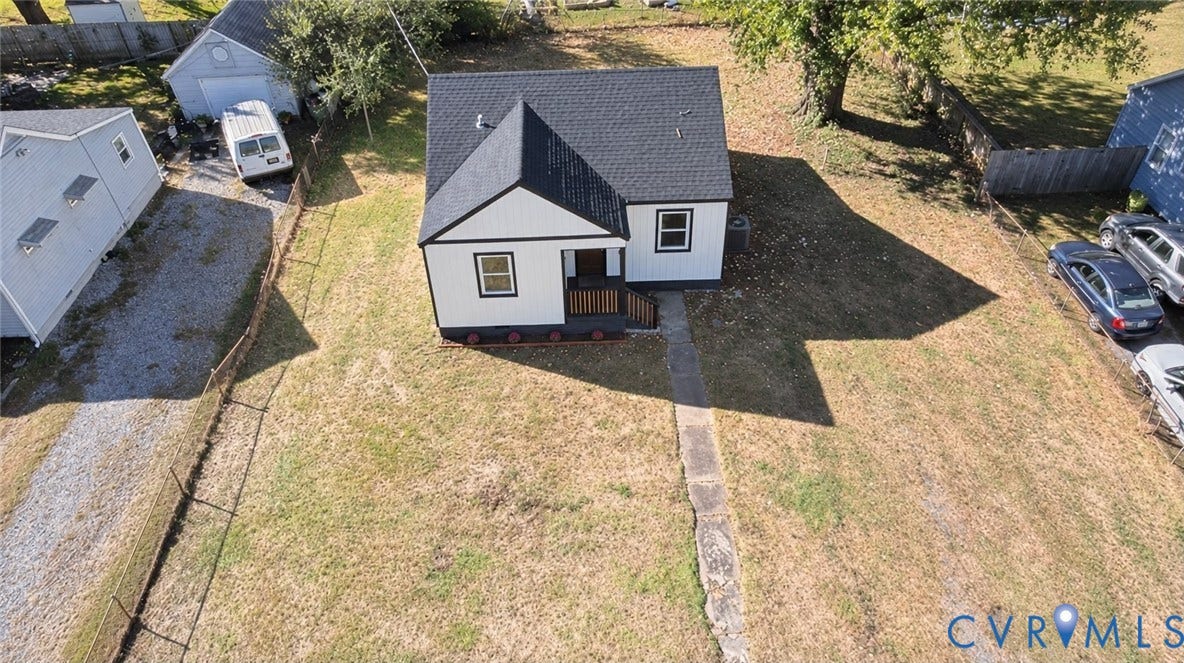 3207 Winchester Street, Henrico, VA 23231 Single-story residence featuring a gable roof, exterior siding with contrast trim, a front-entry porch, and a detached structure located on a lot with a gravel driveway