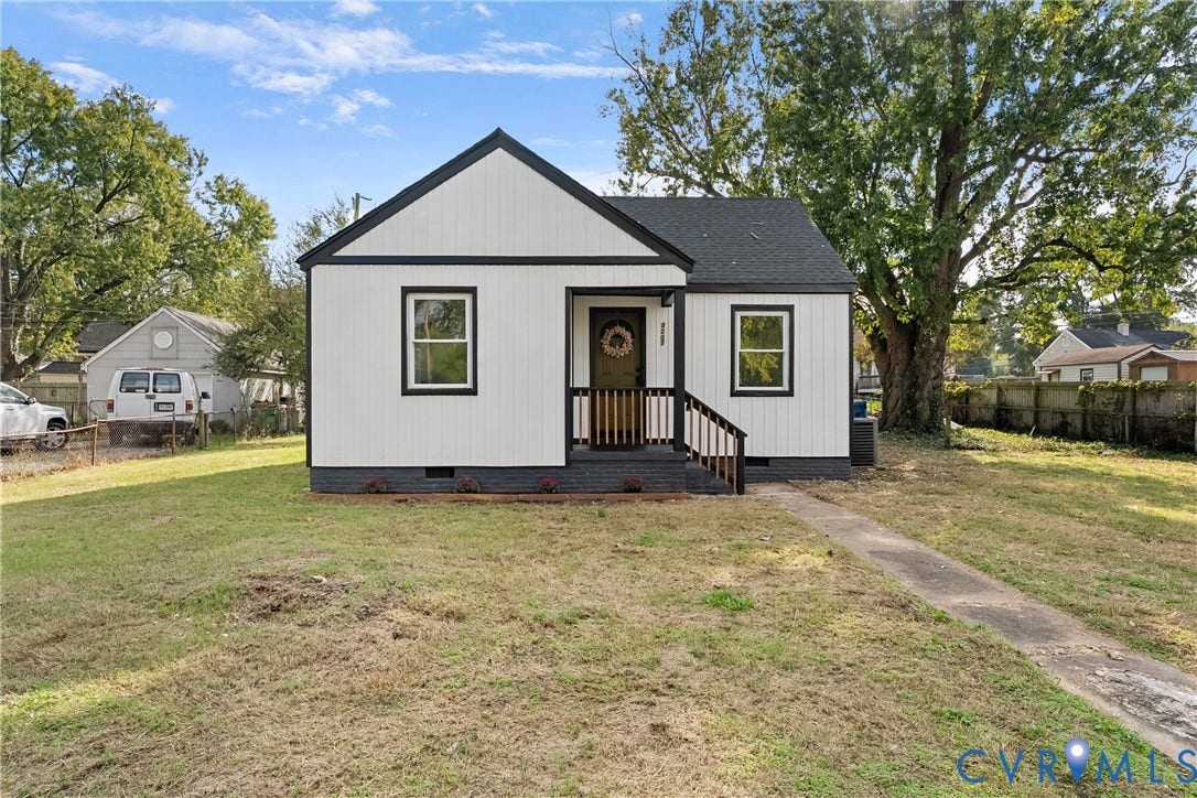 3207 Winchester Street, Henrico, VA 23231 Single-story residence featuring white board-and-batten siding with dark trim, an asphalt shingle roof, a covered front porch with railing, and a concrete walkway