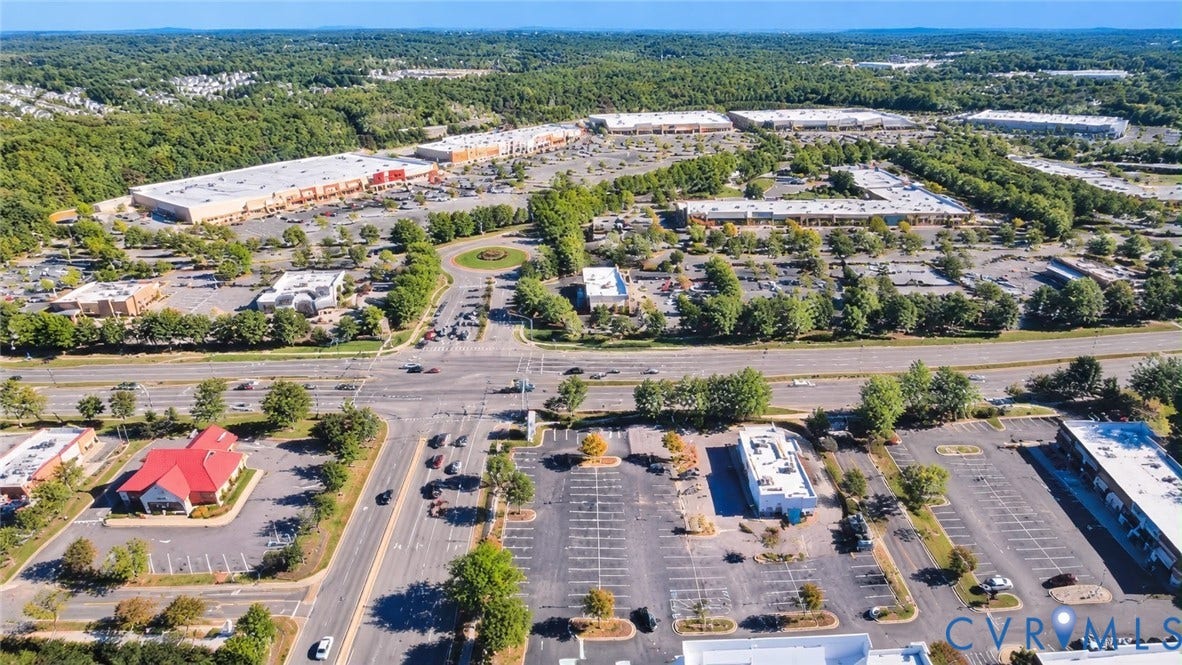 3207 Winchester Street, Henrico, VA 23231 Aerial view of a commercial district featuring paved parking lots, multi-tenant retail structures, professional office buildings, and integrated landscaping