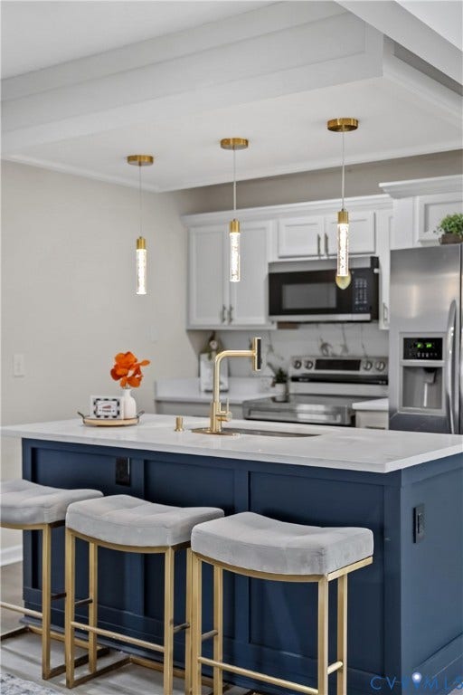 3207 Winchester Street, Henrico, VA 23231 Kitchen island featuring a navy blue cabinet base, quartz countertop, and gold-finish hardware