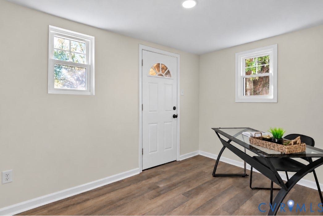 3207 Winchester Street, Henrico, VA 23231 Neutral-toned walls paired with wood-finish flooring, two double-hung windows, and a single-entry door with a semi-circular glass insert