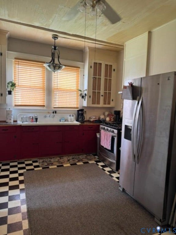 18194 S. Railroad Avenue, Boykins, VA 23827 Kitchen featuring checkerboard tile flooring, built-in cabinetry , stainless steel refrigerator and range, and an integrated basin sink