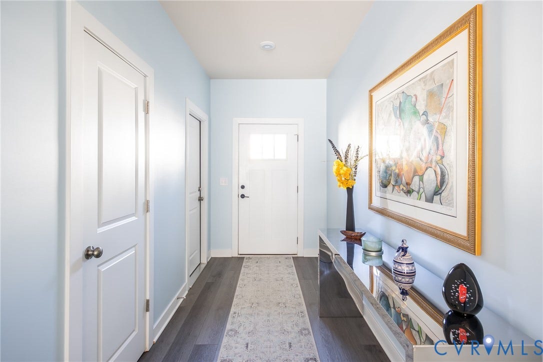 12548 Petrel Crossing, Midlothian, VA 23112 Open interior space featuring light-toned wall paint, wood-finish flooring, a multi-blade ceiling fan, and a staircase with white balusters