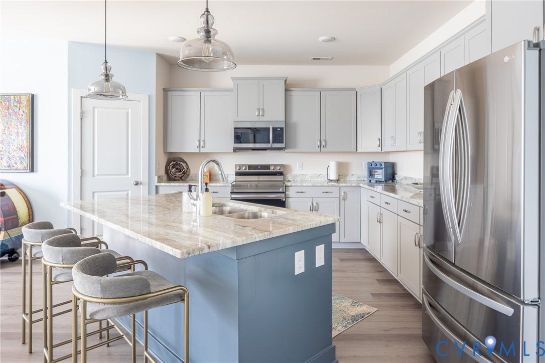 12548 Petrel Crossing, Midlothian, VA 23112 Kitchen featuring light gray cabinetry, a blue-painted center island with a stone-surface countertop, stainless steel appliances, and wood-finish flooring