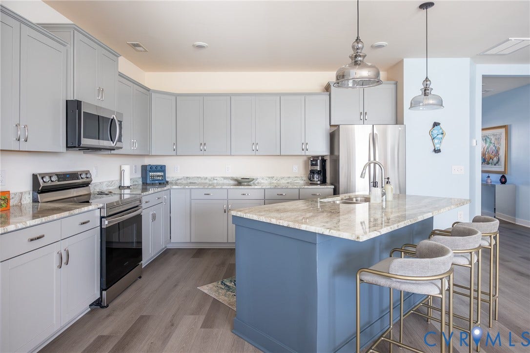 12548 Petrel Crossing, Midlothian, VA 23112 Kitchen featuring gray cabinetry, stone-finish countertops, stainless steel appliances, a center island with a blue base, and pendant lighting