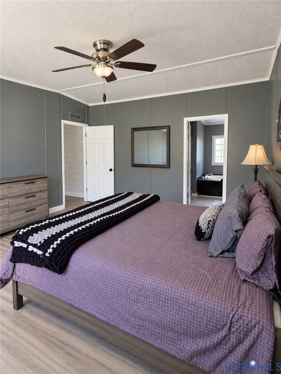 Neutral-toned interior walls, wood-finish flooring, brushed nickel ceiling fan, and white paneled doors