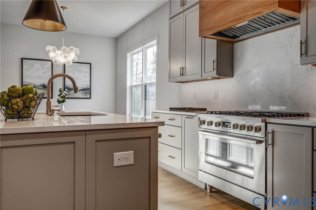 12101 Blunt's Bridge Estates Court, Blunt's Bridge Estates, Doswell, VA 23047 Kitchen featuring shaker-style cabinetry, a quartz countertop, a stainless steel gas range, a wood-finish vent hood, and wood-finish flooring