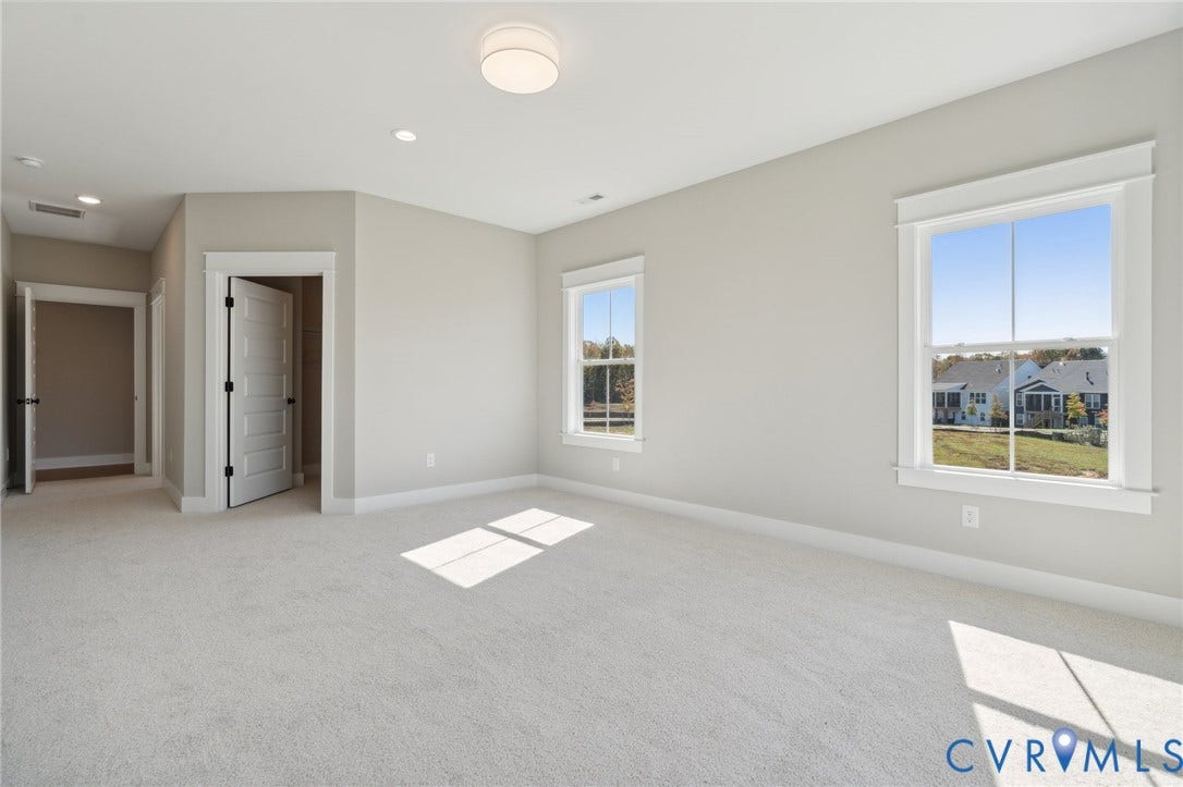 9131 Terroir Lane, Viniterra Villas, New Kent, VA 23124 Neutral wall tones, wall-to-wall carpeting, multi-pane windows with detailed casing, recessed and flush-mount overhead lighting, and multi-panel interior doors