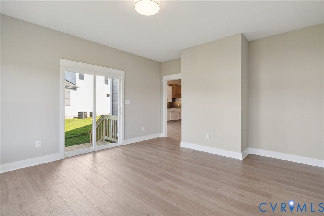 9131 Terroir Lane, Viniterra Villas, New Kent, VA 23124 Neutral interior featuring wood-finish flooring, sliding glass door, flush-mount ceiling lighting, and crisp wall finishes
