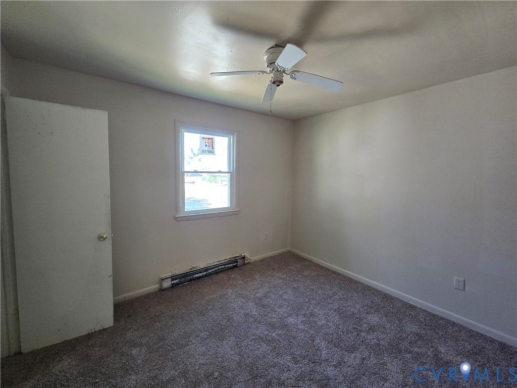 320 Shore Street, Petersburg, VA 23803 Room featuring neutral carpeting, a ceiling fan, and a single-pane window with a white frame