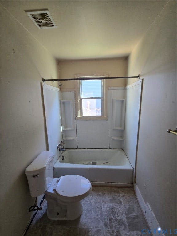 320 Shore Street, Petersburg, VA 23803 Bathroom featuring a white porcelain toilet, bathtub with integrated shelving, and tiled flooring
