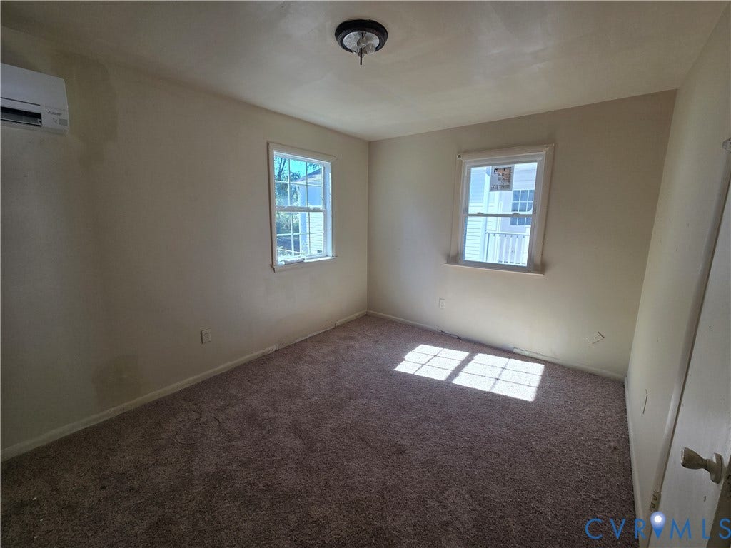 320 Shore Street, Petersburg, VA 23803 Wall-mounted ductless HVAC unit, double-hung windows with muntin grids, and wall-to-wall carpeting