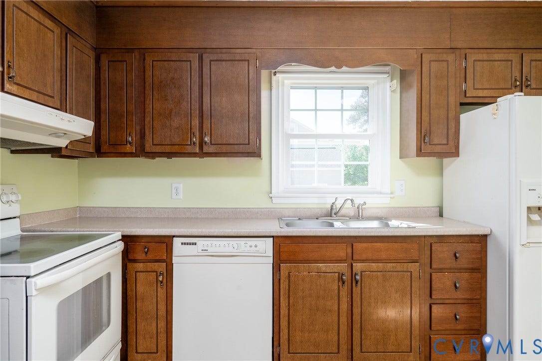 9329 Totopotomoy Trail, Ashland, VA 23005 Kitchen featuring wood cabinetry, integrated white appliances, a solid-surface countertop, and a double-basin stainless steel sink