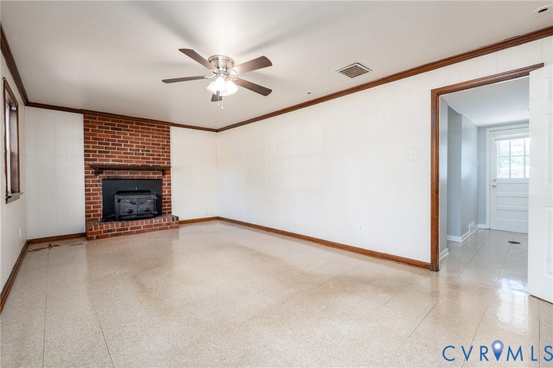 9329 Totopotomoy Trail, Ashland, VA 23005 Brick fireplace with integrated stove insert, tile flooring, crown molding, and ceiling fan