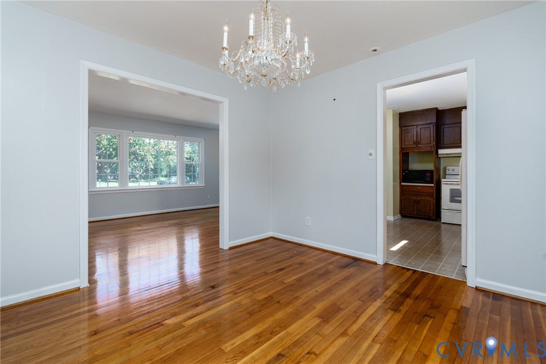 9329 Totopotomoy Trail, Ashland, VA 23005 Dining area featuring wood-finish flooring, a decorative crystal chandelier, and neutral wall tones