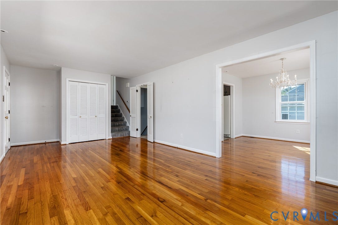 9329 Totopotomoy Trail, Ashland, VA 23005 Wood-finish flooring throughout, multi-panel louvered closet doors, carpeted staircase, and decorative crystal chandelier