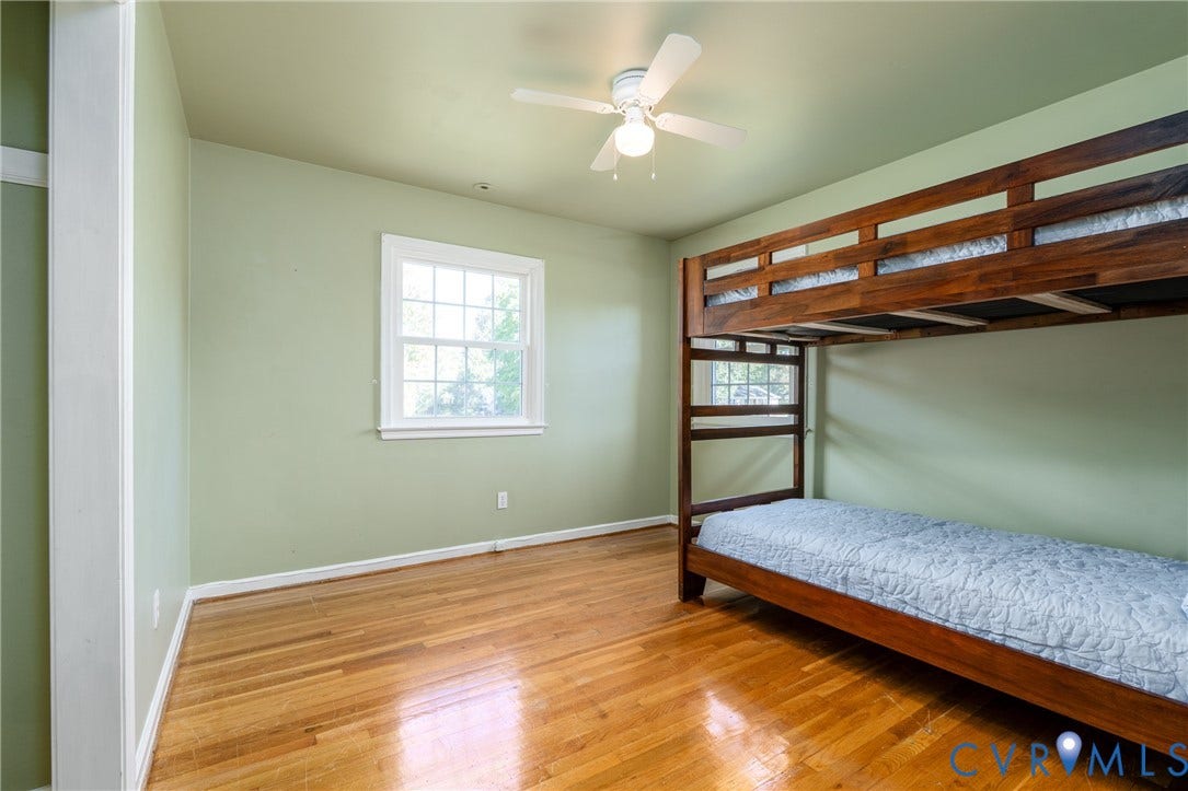 9329 Totopotomoy Trail, Ashland, VA 23005 Room featuring wood-finish flooring, a multi-pane window, and a ceiling-mounted light fixture with a fan