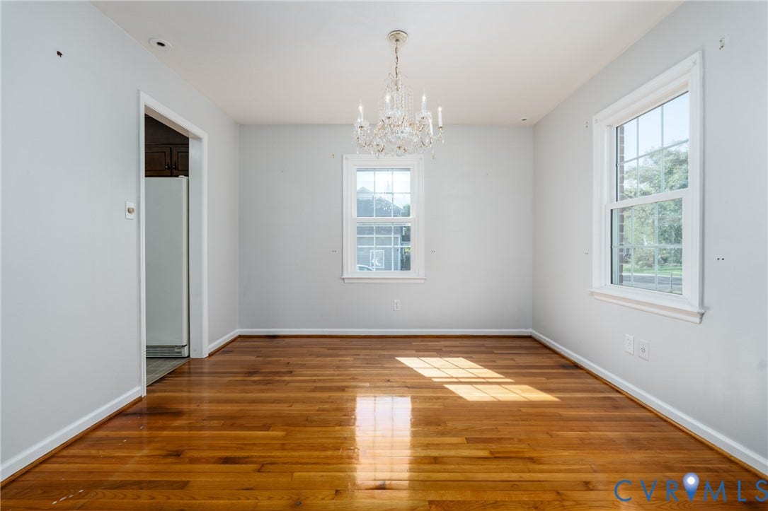9329 Totopotomoy Trail, Ashland, VA 23005 Bright, light-filled room showcasing pristine hardwood flooring, white walls, and abundant natural light from multiple windows