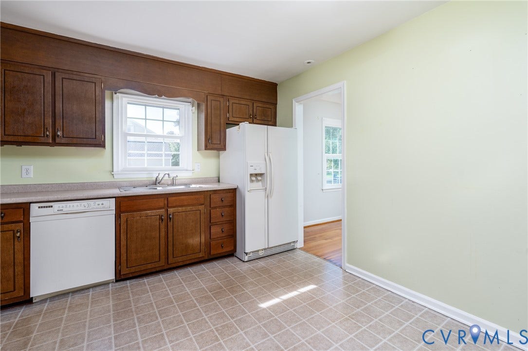 9329 Totopotomoy Trail, Ashland, VA 23005 Kitchen featuring wood cabinetry, laminate countertops, a double-basin stainless steel sink, a dishwasher, and a refrigerator