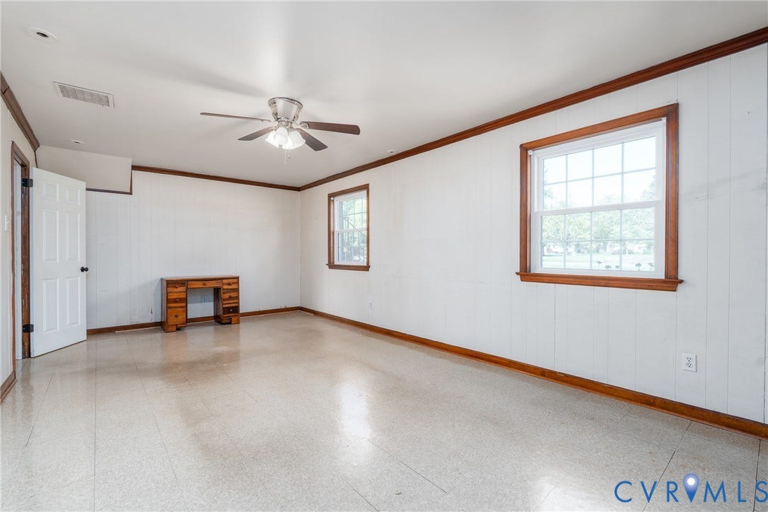 9329 Totopotomoy Trail, Ashland, VA 23005 Room featuring white paneled walls, wood-finish trim, tile flooring, and a ceiling-mounted light fixture with a fan