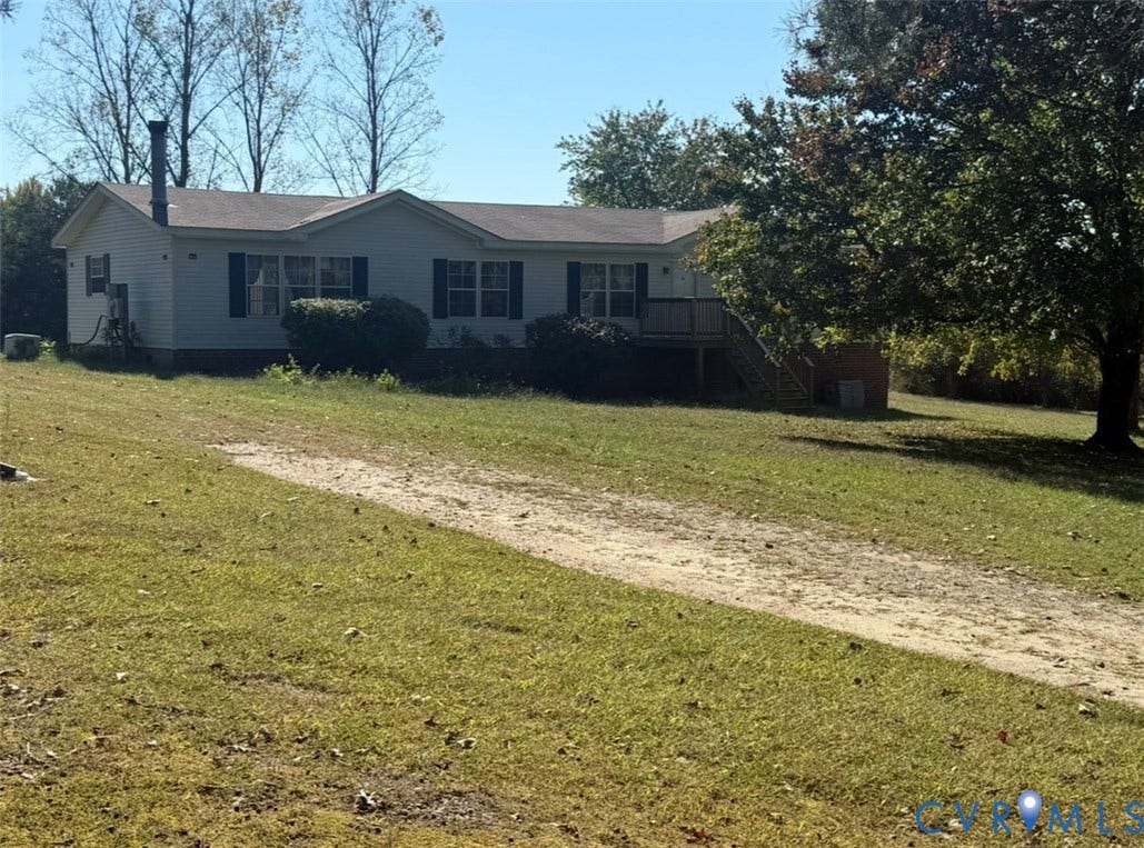 26691 Bell Road, Amelia, VA 23002 Single-story residence featuring light-colored siding, a shingled roof, a chimney, and a raised wooden deck