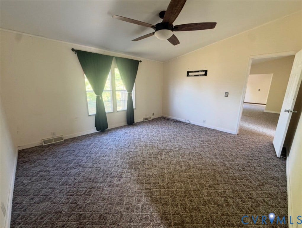26691 Bell Road, Amelia, VA 23002 Room featuring vaulted ceilings, a ceiling fan with integrated lighting, patterned wall-to-wall carpeting, and dual-pane windows