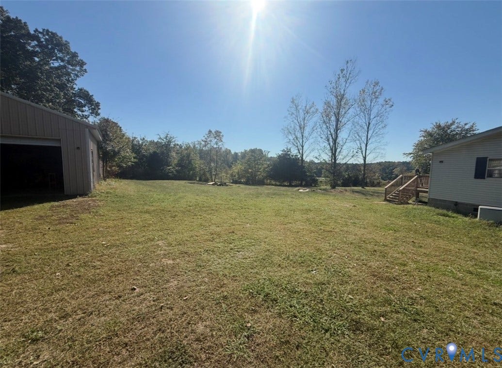 26691 Bell Road, Amelia, VA 23002 Expansive lot featuring a detached outbuilding, a tiered wood deck, and mature trees