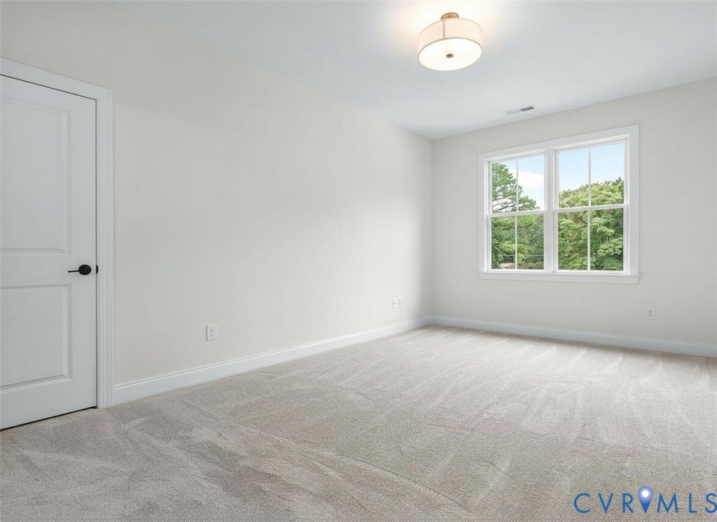 2851 Old Pump Road, Preserve At John Rolfe, Henrico, VA 23233 Neutral-toned carpeting, double-hung windows, flush-mount drum lighting, and a paneled interior door with matte black hardware