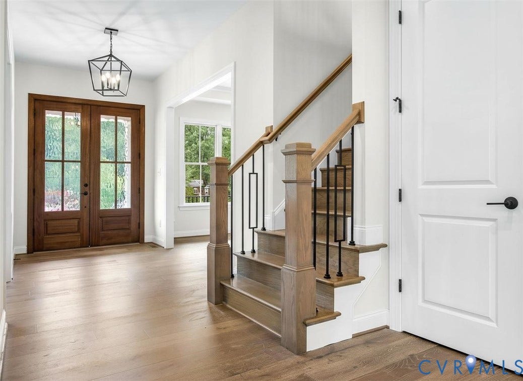 2851 Old Pump Road, Preserve At John Rolfe, Henrico, VA 23233 Entryway featuring double wood-paneled doors, wood-finish flooring, a geometric metal pendant light, and a staircase with wood handrails and black metal balusters