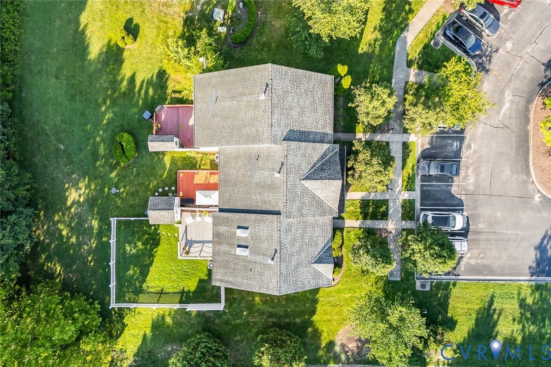958 Wellston Court, Henrico, VA 23059 Aerial perspective of property featuring shingled roofing, multiple skylights, and tiered outdoor decks within a fenced-in grassy lawn