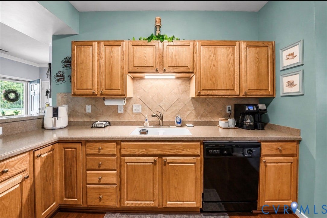 958 Wellston Court, Henrico, VA 23059 Kitchen featuring natural wood cabinetry, solid surface countertops, a white undermount sink, a diagonal-patterned tile backsplash, and a black dishwasher
