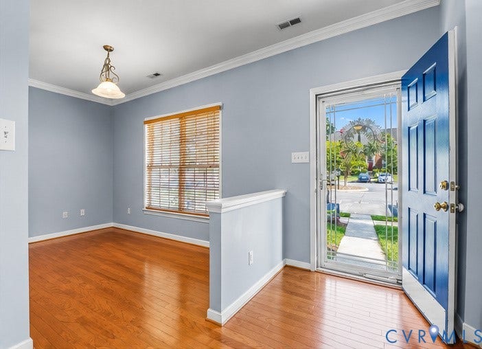 958 Wellston Court, Henrico, VA 23059 Entryway featuring wood-finish flooring, a six-panel door, decorative metal-frame screen door, crown molding, and a pendant light fixture