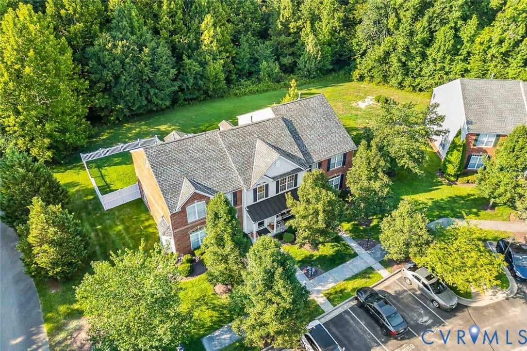 958 Wellston Court, Henrico, VA 23059 Multi-story brick and siding exterior featuring an asphalt shingle roof, white vinyl fencing, concrete walkways, and mature landscaping