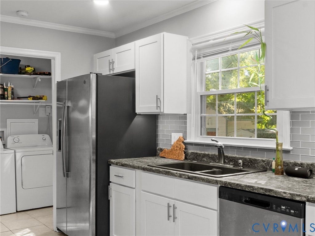 8708 Rainwater Road, Huntingcreek Hills, North Chesterfield, VA 23237 Kitchen featuring white shaker-style cabinetry, dark stone-patterned countertops, gray subway tile backsplash, stainless steel appliances, and a double-basin sink