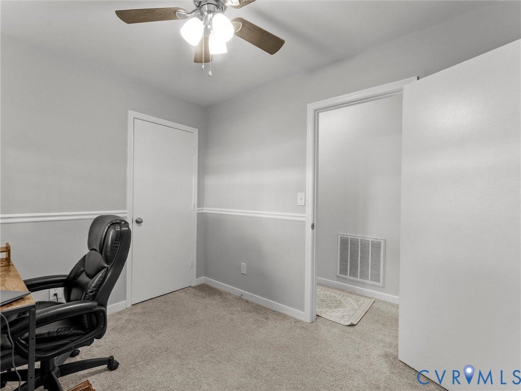 8708 Rainwater Road, Huntingcreek Hills, North Chesterfield, VA 23237 Neutral-toned interior featuring wall-mounted chair rail molding, wall-to-wall carpeting, and a ceiling-mounted light fixture with a multi-blade fan