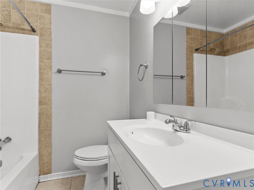 8708 Rainwater Road, Huntingcreek Hills, North Chesterfield, VA 23237 Bathroom featuring a vanity with integrated sink, tri-panel medicine cabinet, chrome fixtures, and a tub-shower combination with tile surround