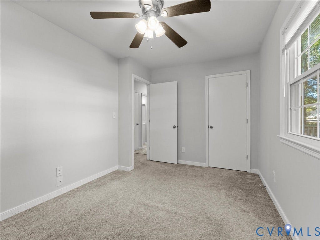 8708 Rainwater Road, Huntingcreek Hills, North Chesterfield, VA 23237 Neutral-toned wall paint, neutral carpeting, multi-light ceiling fan, and a multi-pane window