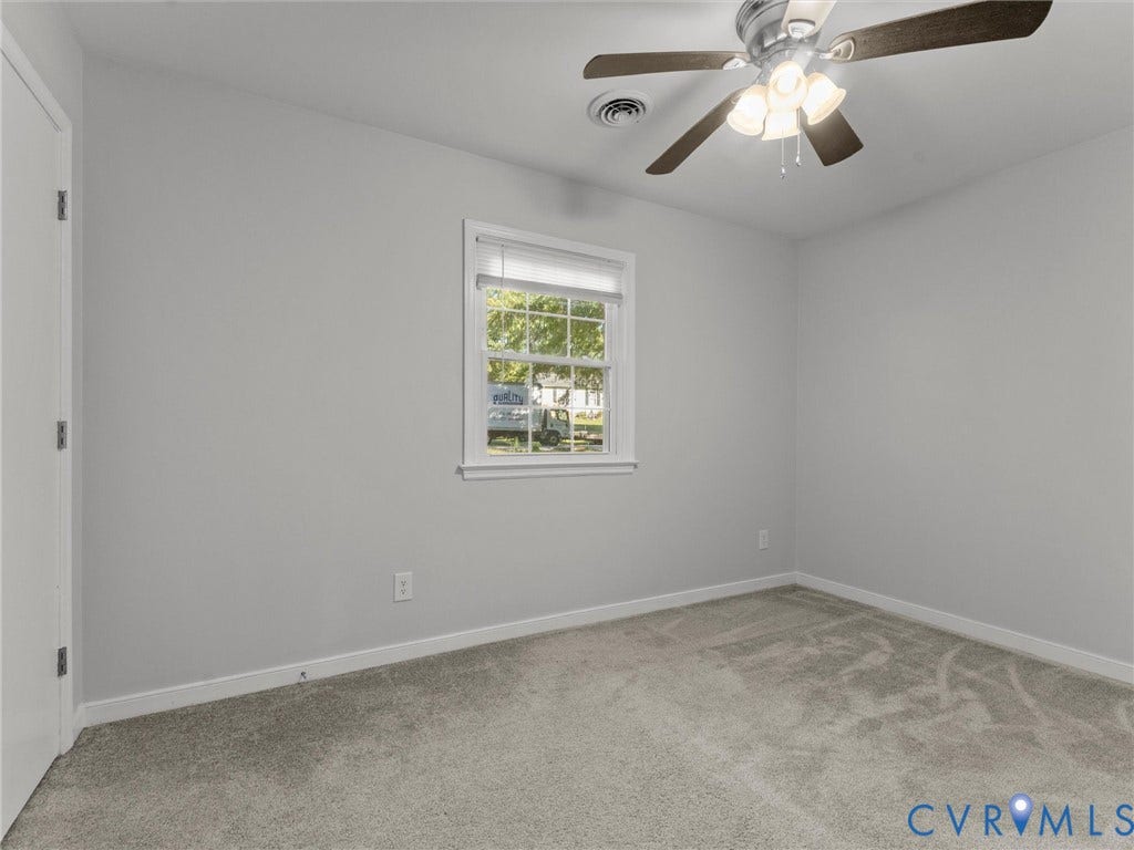 8708 Rainwater Road, Huntingcreek Hills, North Chesterfield, VA 23237 Neutral-toned interior featuring wall-to-wall carpeting, a multi-pane window with blinds, and a ceiling fan with integrated lighting