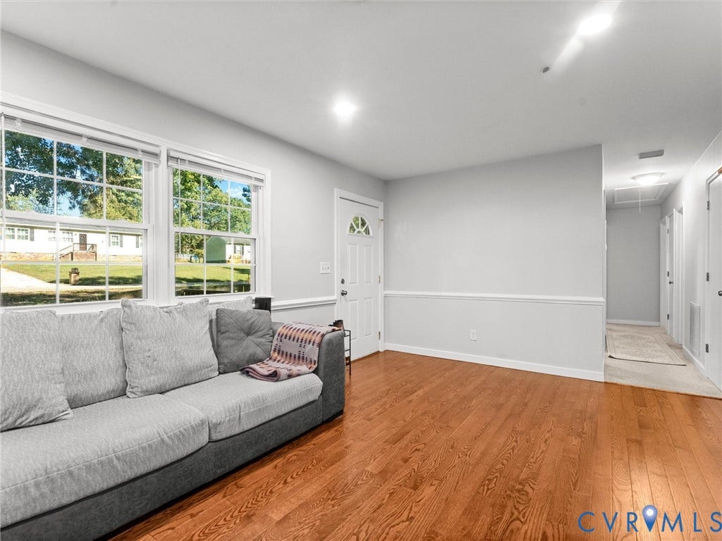 8708 Rainwater Road, Huntingcreek Hills, North Chesterfield, VA 23237 Room featuring wood-finish flooring, crisp white wall trim, and multi-pane windows providing natural light