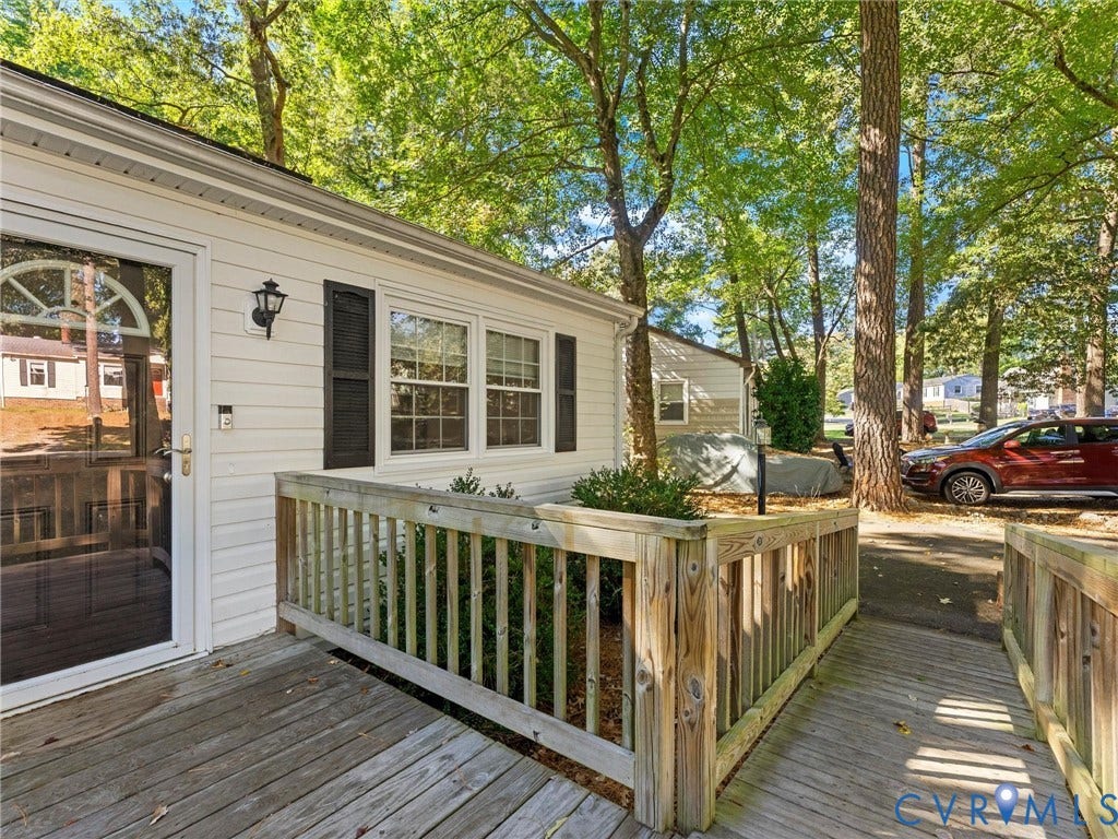 8708 Rainwater Road, Huntingcreek Hills, North Chesterfield, VA 23237 Exterior featuring horizontal siding, dark louvered shutters, wood-finish decking, and a wood-railing enclosure