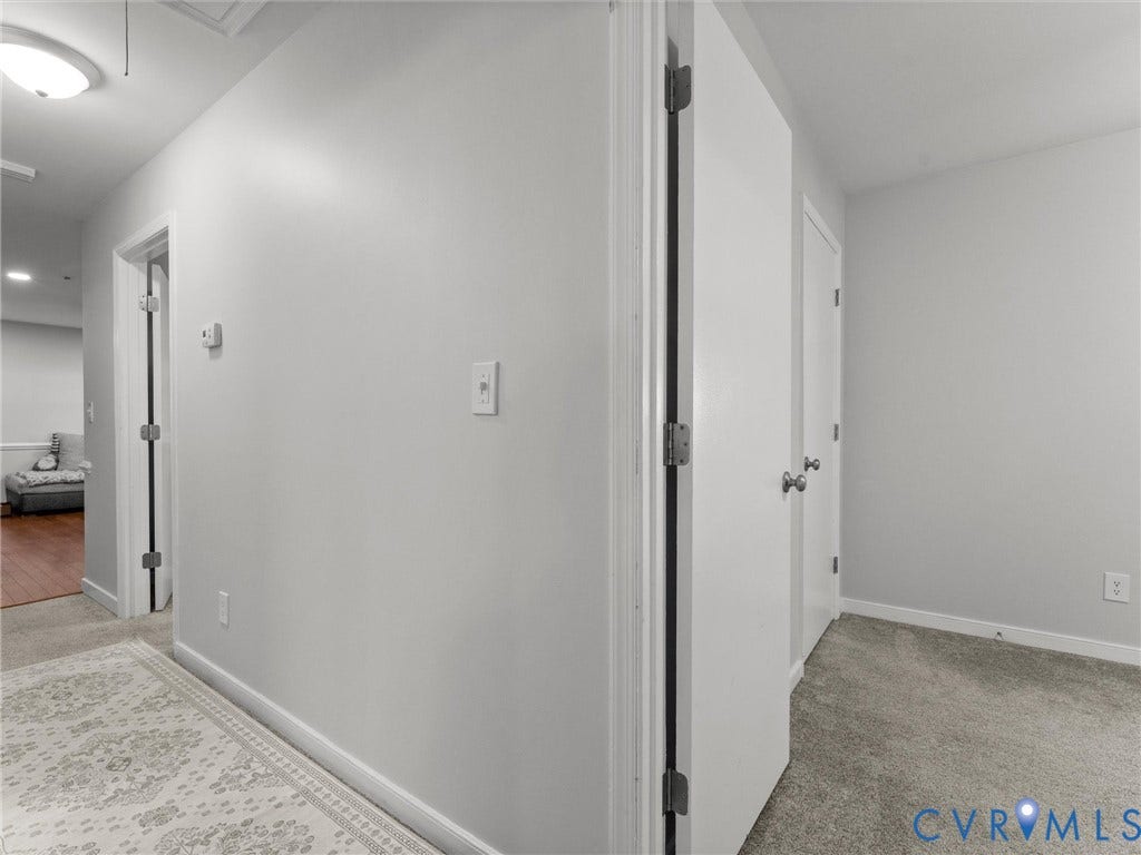 8708 Rainwater Road, Huntingcreek Hills, North Chesterfield, VA 23237 Neutral-toned interior featuring grey wall paint, plush carpeting, white interior doors with brushed nickel hardware, and a flush-mount ceiling light fixture