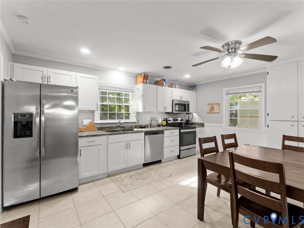 8708 Rainwater Road, Huntingcreek Hills, North Chesterfield, VA 23237 Kitchen featuring white shaker-style cabinetry, stainless steel appliances, tiled flooring, solid-surface countertops, and a ceiling fan with integrated lighting
