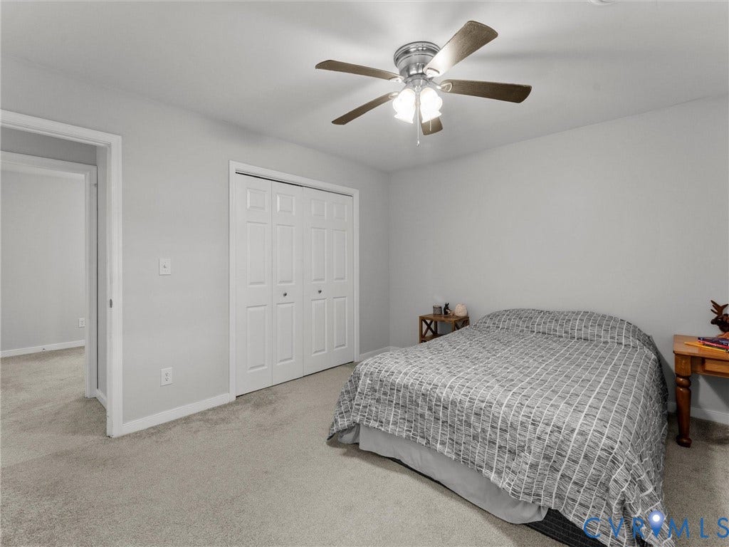 8708 Rainwater Road, Huntingcreek Hills, North Chesterfield, VA 23237 Neutral-toned carpeting, white bi-fold closet doors, and a ceiling fan with integrated multi-bulb lighting