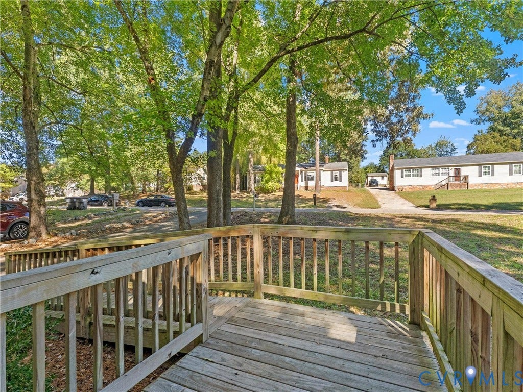8708 Rainwater Road, Huntingcreek Hills, North Chesterfield, VA 23237 Raised wooden deck featuring wood balustrades and a multi-level design overlooking a tree-lined lot