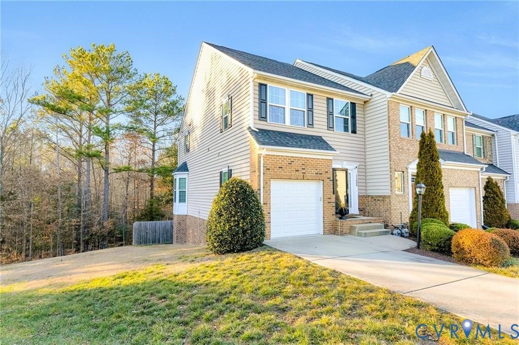 11600 Vicars Ridge Lane, Henrico, VA 23059 View of front of home with brick siding, a front lawn, fence, driveway, and an attached garage